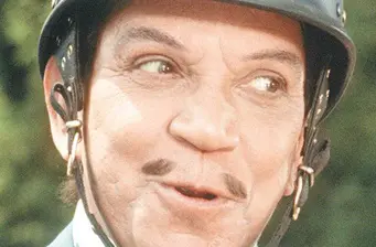 close-up of man in vintage helmet as Cantinflas character