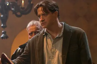 two men in tense moment, one in foreground focused, other behind