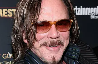 Mickey Rourke close-up with tinted glasses smiling