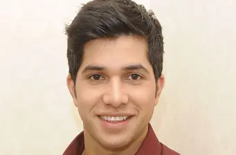 Headshot of Latino actor Walter Perez smiling directly at camera