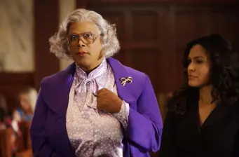 Tyler Perry as Madea wearing purple coat in courtroom scene