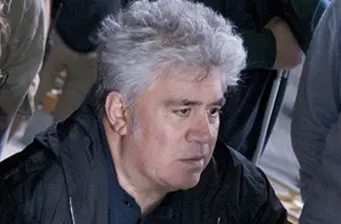 candid headshot of a gray-haired man in dark jacket