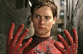 Tobey Maguire as Spider-Man examines gloves in alley scene