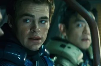 Two men in Starfleet uniforms inside ship, tense expressions