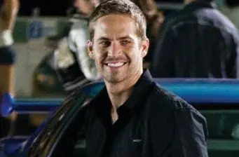 Smiling man in black shirt at outdoor event