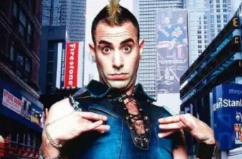 Sacha Baron Cohen as Bruno posing with hands near chest outdoors