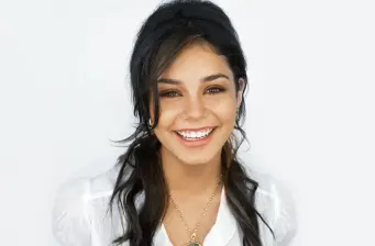 Vanessa Hudgens smiling in casual white top headshot