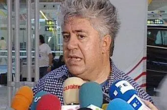 Pedro Almodóvar speaks to press with colorful microphones
