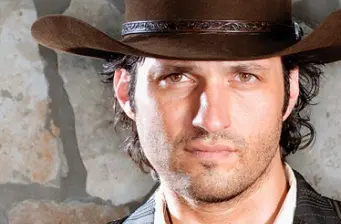 Robert Rodriguez in brown cowboy hat close-up headshot