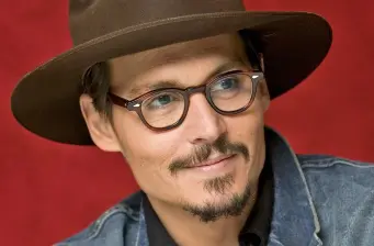 Johnny Depp headshot wearing brown hat and glasses