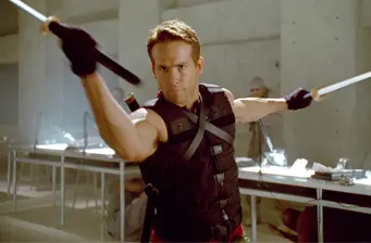 Deadpool character in action wielding two swords indoors
