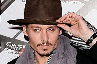 Johnny Depp tipping hat in close-up portrait photo