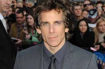 Ben Stiller in gray suit at event with crowd behind him