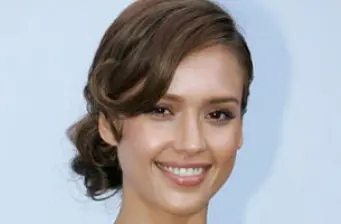 Headshot of Jessica Alba smiling with hair styled to the side