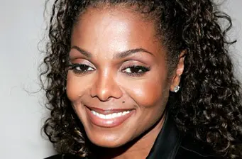 Janet Jackson close-up portrait smiling with curly hair