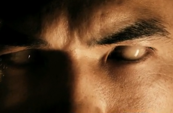 Close-up of man with white eyes, intense facial expression