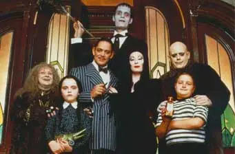 The Addams Family cast in costume posing for a group photo