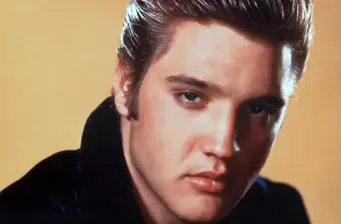 Close-up headshot of Elvis Presley with slicked-back hair