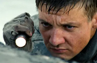 Close-up of man holding flashlight, looking intense and focused