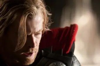 Thor close-up looking down in costume with red cape