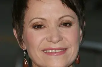 Close-up headshot of unidentified smiling woman with short hair