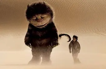Child walks beside large creature in foggy desert from Where the Wild Things Are