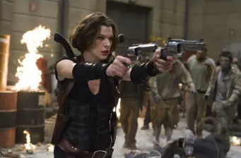 Woman in black shoots two guns at zombies indoors