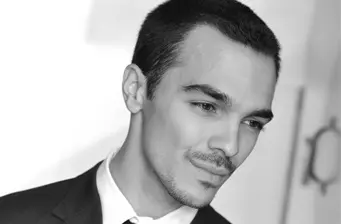 Close-up headshot of Puerto Rican actor Shalim Ortiz looking down