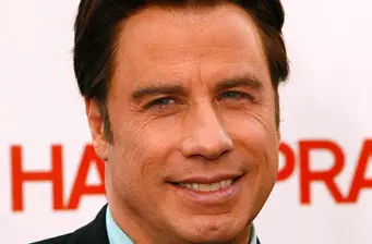 Headshot of actor John Travolta smiling with red text background