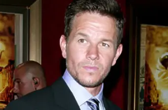 Close-up headshot of Mark Wahlberg looking off camera indoors