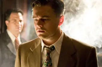 Leonardo DiCaprio in period suit, tense expression in movie scene
