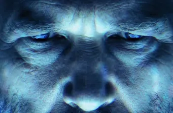 intense close-up of man's face under blue sci-fi lighting