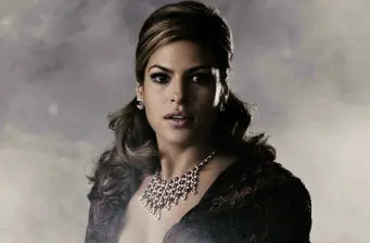 Eva Mendes in elegant headshot wearing necklace and dark outfit