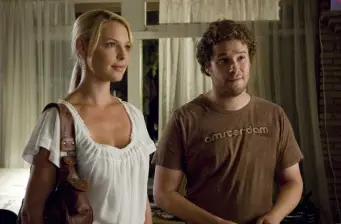 man and woman standing indoors in casual conversation scene