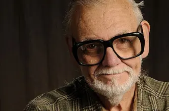 Close-up of George Romero with large glasses and white beard
