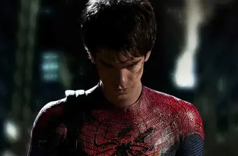 Andrew Garfield in Spider-Man suit looking downward at night