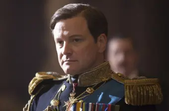 Man in ornate blue and gold military uniform looking serious