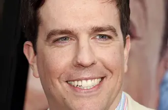 Ed Helms smiling in a close-up headshot photo