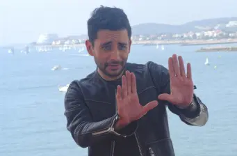 Spanish director Jaume Collet-Serra gesturing by the water