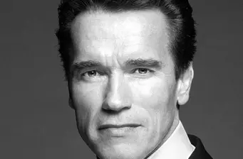 Black and white close-up headshot of Arnold Schwarzenegger