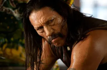 Close-up headshot of Mexican-American actor Danny Trejo with long hair