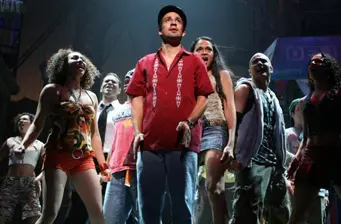 group of stage performers in casual clothes during In the Heights show