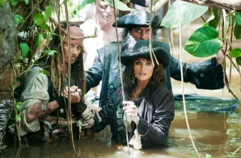 Three pirates in swamp water gripping weapons, looking alert