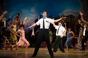 The Book of Mormon cast dancing mid-performance on stage