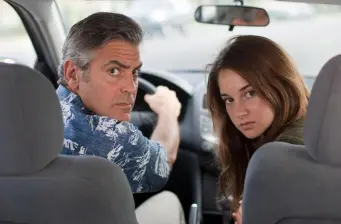 man and woman in a car looking back toward camera