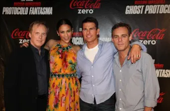 Four people posing at Mission Impossible Ghost Protocol event