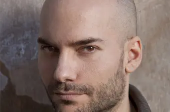 Close-up headshot of director F. Javier Gutiérrez looking serious
