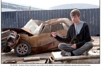 Andrew Detmer quietly sits by crushed car using telekinetic power