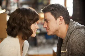 man and woman face each other closely in a quiet moment