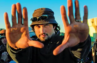 Mexican-American filmmaker Robert Rodriguez frames shot with hands outdoors